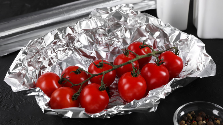 Fresh tomatoes sitting on aluminum foil