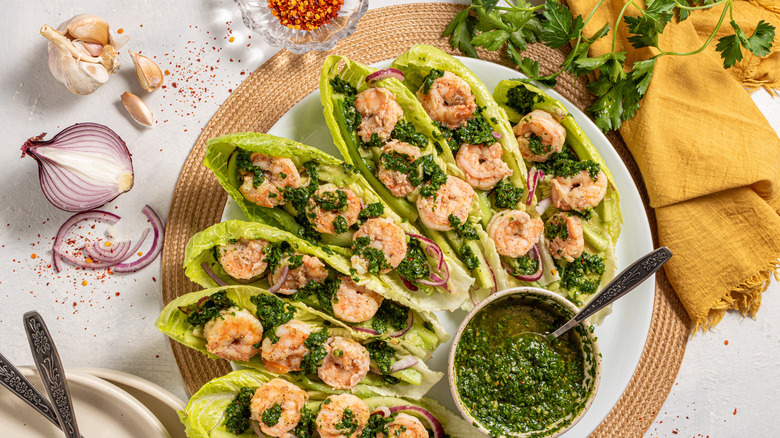 Shrimp lettuce wraps with chimichurri sauce on a plate