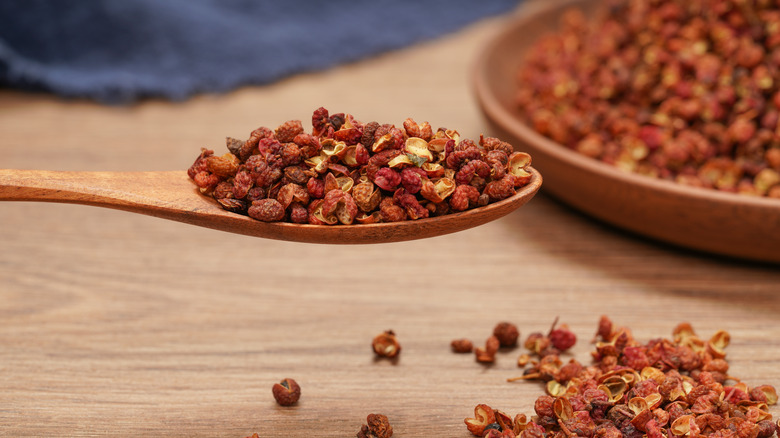 Sichuan peppercorns on wooden spoon