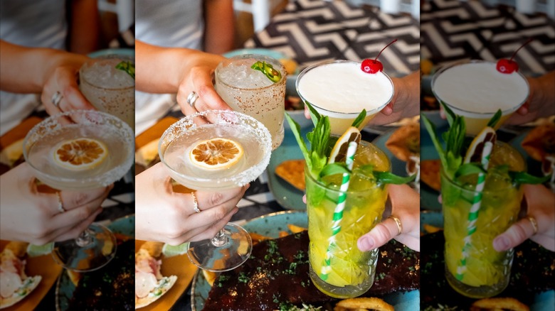 Hands holding mixed dinks at On the Border table