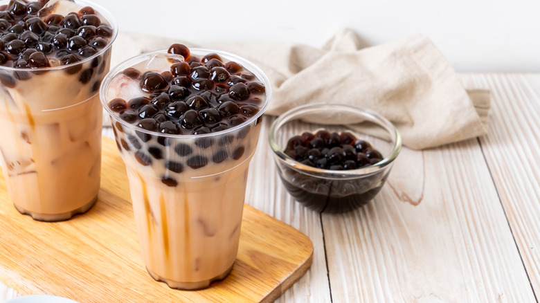 Two boba teas and bowl of tapioca pearls