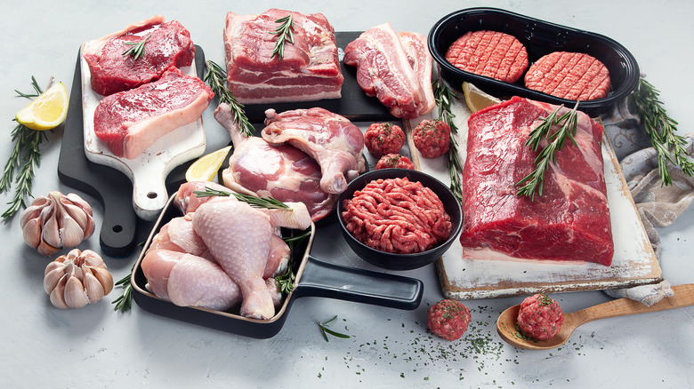 raw chicken and beef in cooking pans