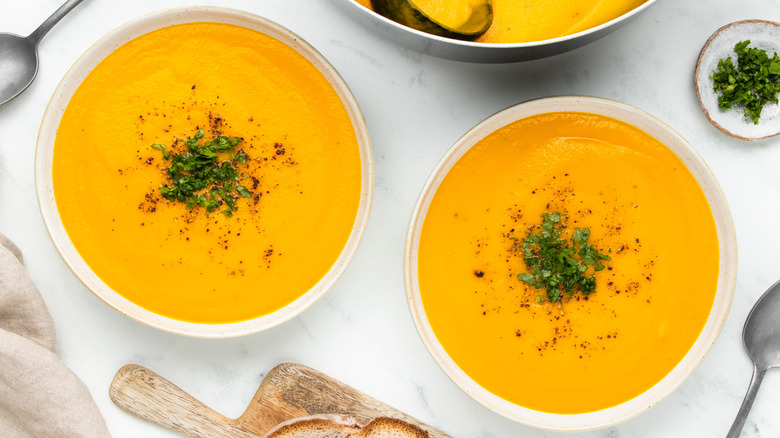 two bowls of carrot soup