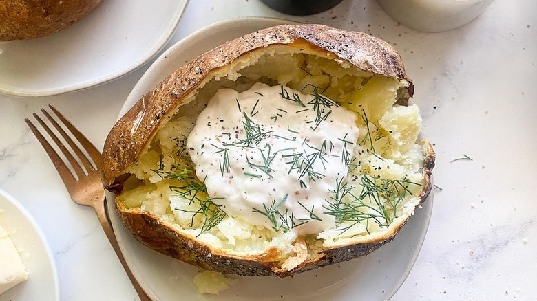 baked potato with sour cream and herbs