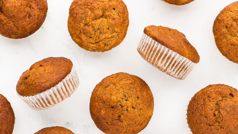 Banana carrot muffins arranged on white background