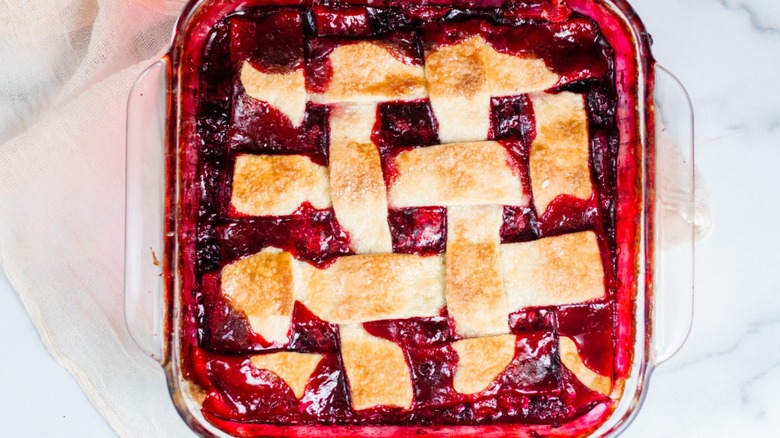 Blackberry cobbler with pie crust and whipped cream on top