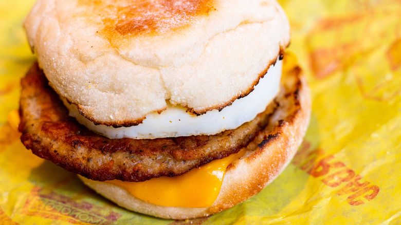 Closeup of sausage egg McMuffin on paper