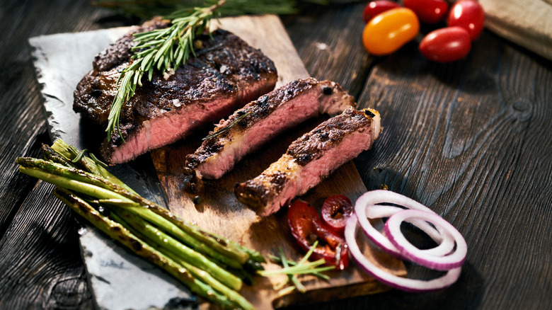 Sliced steak on wooden board