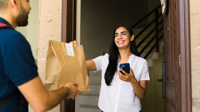 person receiving food delivery at front door