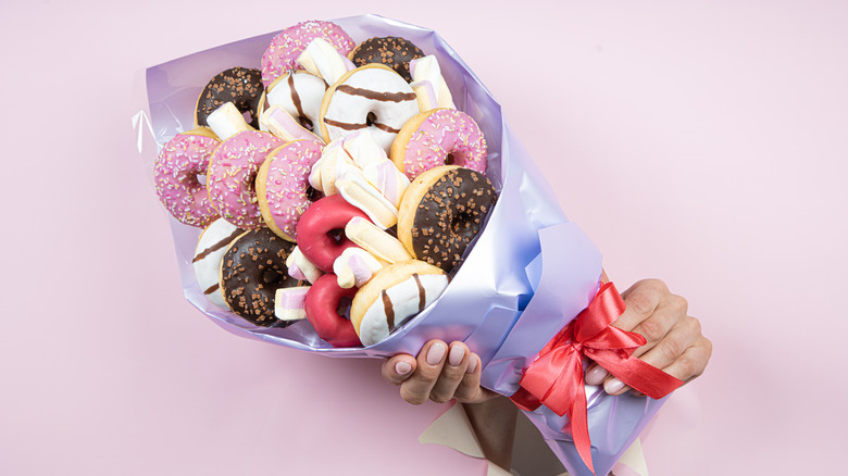 Person holding donut bouquet