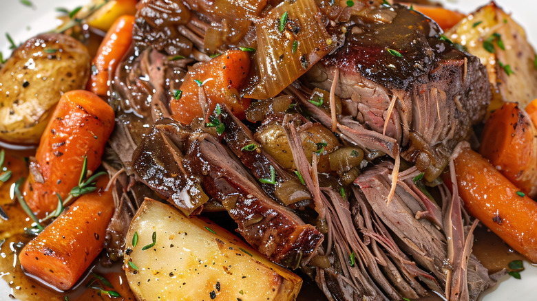 A plate of pot roast with carrots