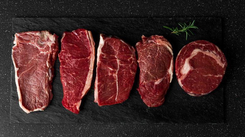 platter of uncooked steaks