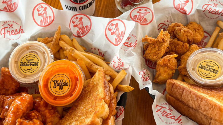 Baskets of wings and tenders at Slim Chickens with a variety of their specialty sauces.