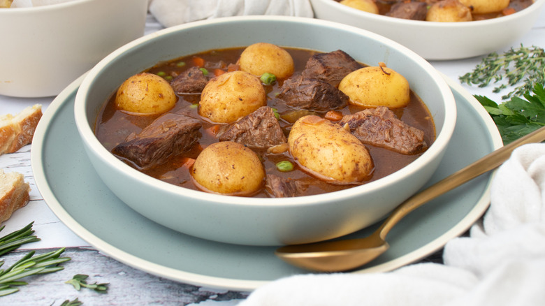 slow cooker beef stew in bowl with bread