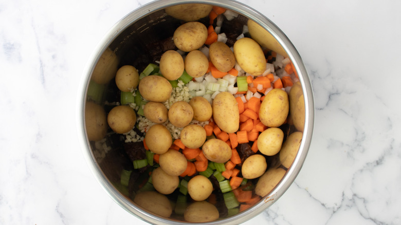 vegetables and meat in slow cooker pot