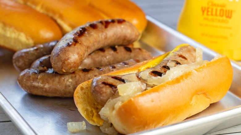 bratwurst with onions on tray