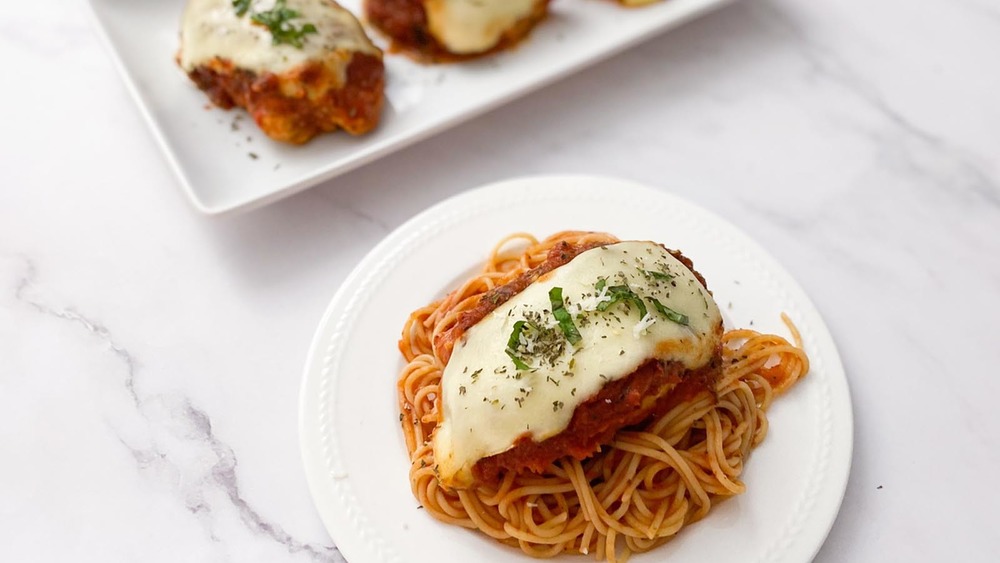 chicken Parmesan on a bed of spaghetti noodles