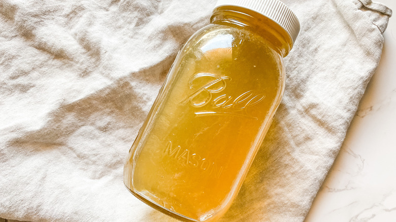 Slow cooker chicken stock recipe in a mason jar 