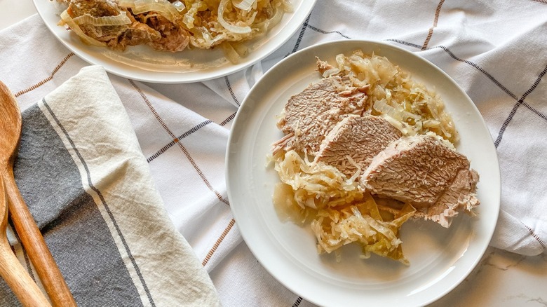 Slow Cooker Pork And Sauerkraut With Apples on plates