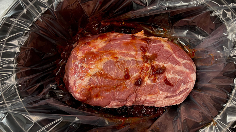 Pork butt roast in lined slow cooker