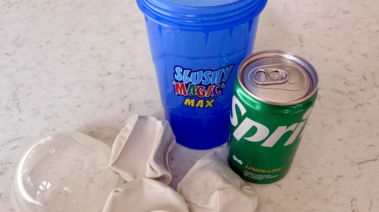 A Slushy Magic Max cup with magic freezer cubes and a can of Sprite