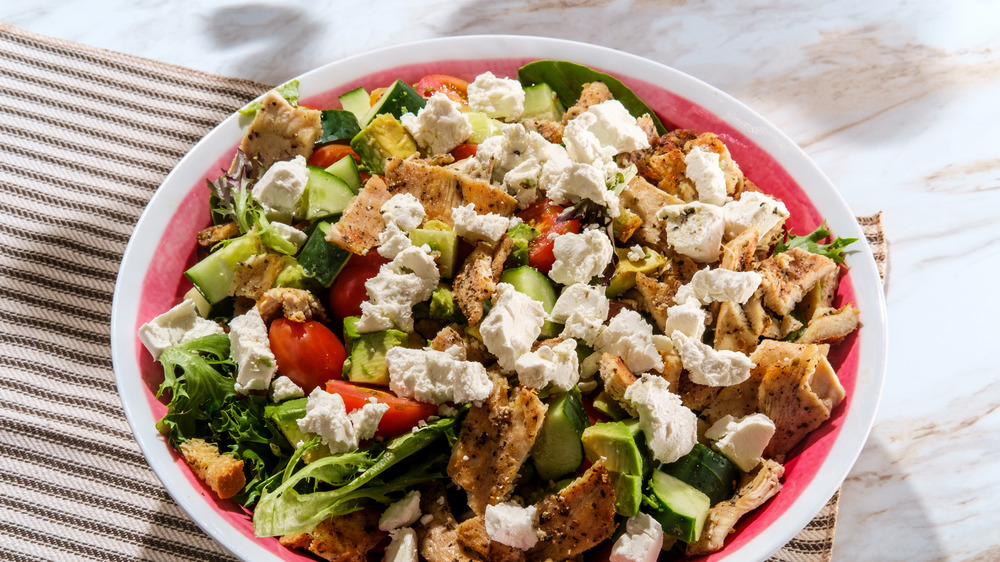 Large salad on plate and tablecloth 