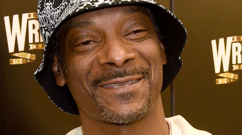 Snoop Dogg smiling in hat