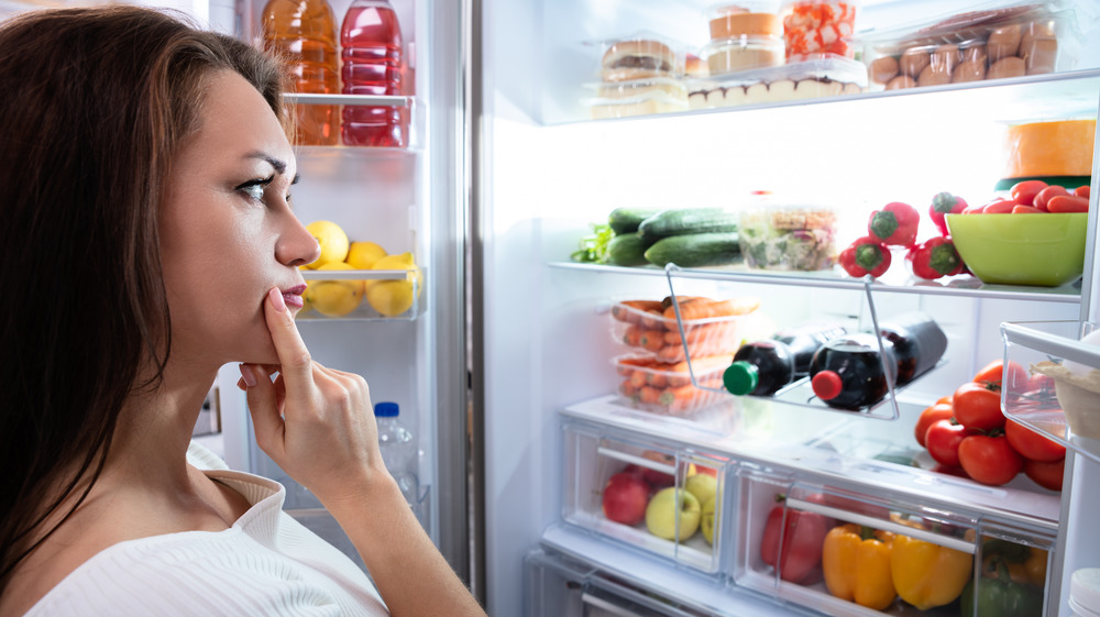 Woman looking in refrigerator