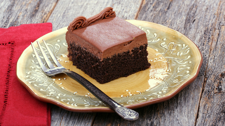 Slice of chocolate sheet cake with chocolate frosting.