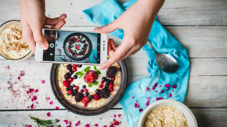 Hands with phone taking picture of pie