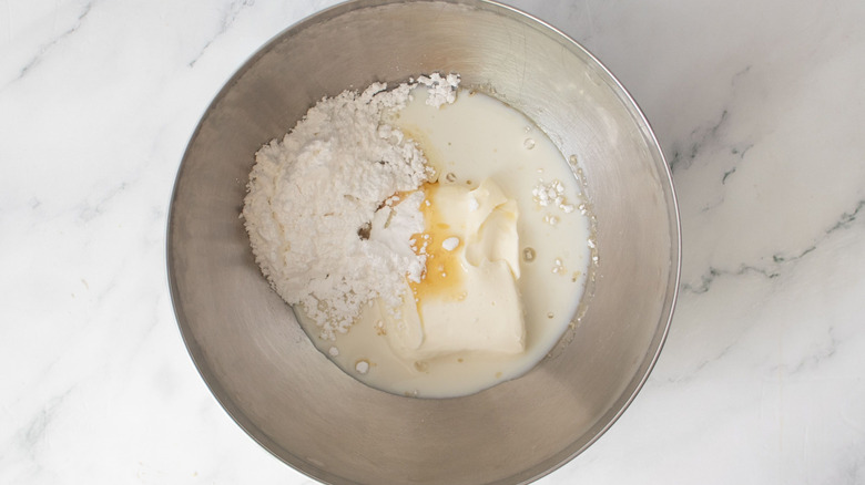 Cream cheese, powdered sugar, and syrup in mixing bowl