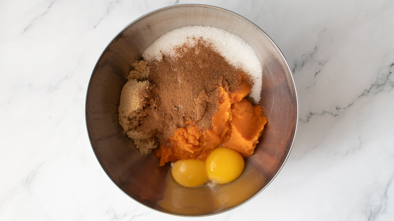 Pumpkin pie filling ingredients unmixed in bowl