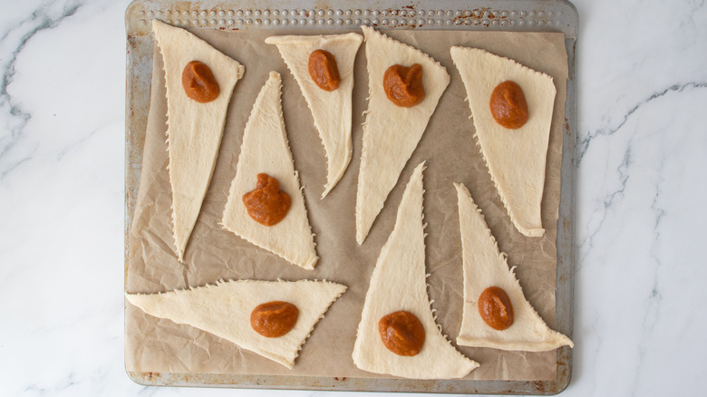Unrolled crescent rolls with dollop of pumpkin filling on each