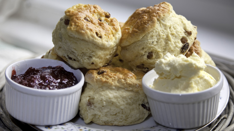 Scones with jam and cream on plate