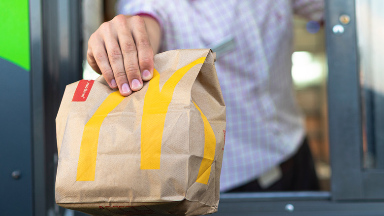 A bag is held out at a McDonald's drive-thru