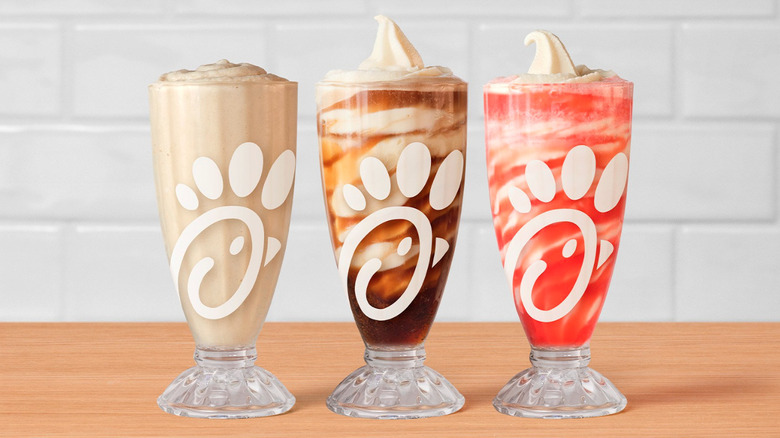 Chick-fil-A's Frosted Soda and Float in clear glasses with the brand's logo.