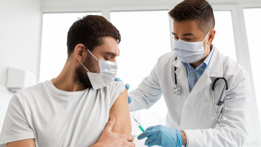 Doctor giving a person a vaccination