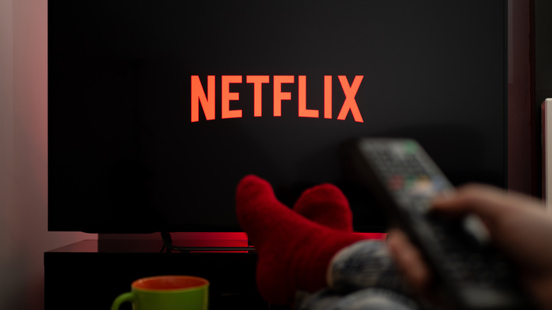 Person with feet up and Netflix on TV