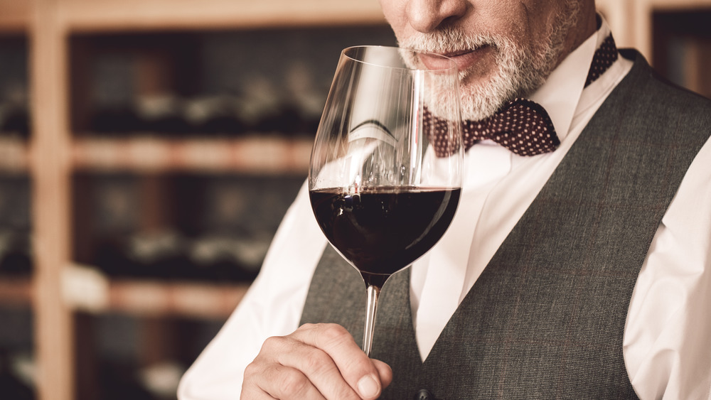 Distinguished sommelier evaluating wine