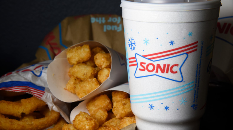 Sonic soft drink next to packages of tater tots