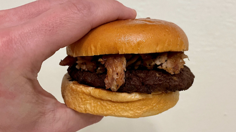 Hand holding burger