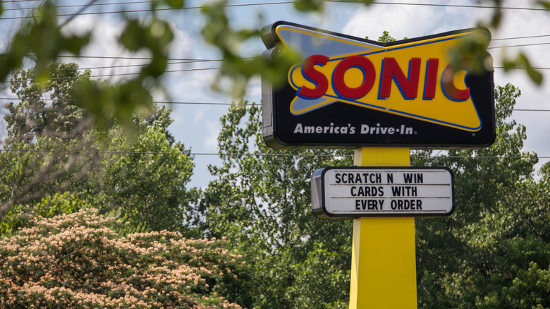 Sonic drive-in sign behind leaves