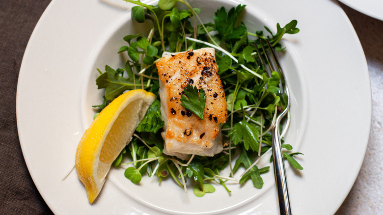 seabass on plate with microgreens and arugula