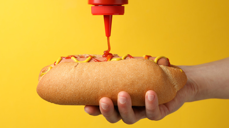 squirting ketchup on hot dog