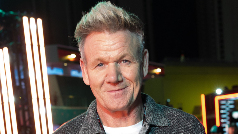 Gordon Ramsay smiles in front of bright lights