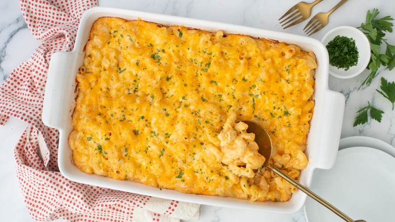 Baked mac and cheese in casserole dish with spoon