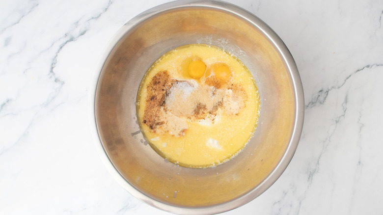 Eggs, milk, butter, and various spices in bowl