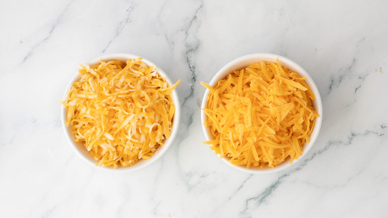 Shredded cheese in small bowls