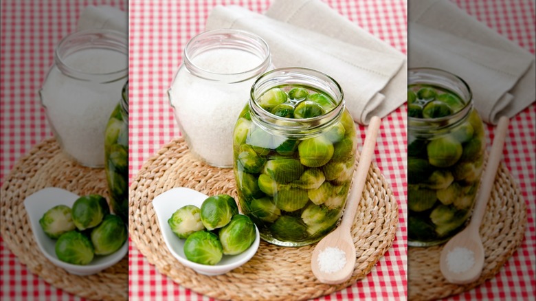 Brussels sprouts in jar and dish next to jar of salt