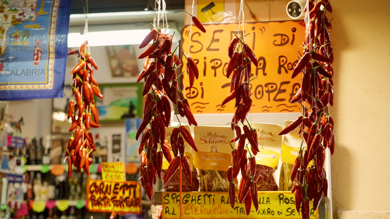 Strings of chile peppers hanging in front of Calabrian market